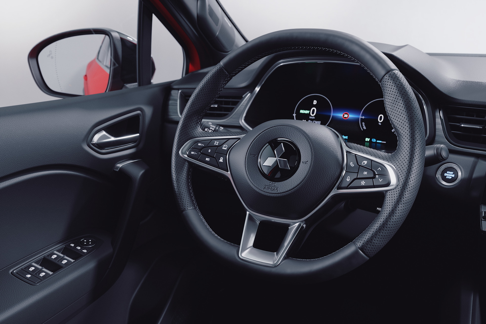 Vista detallada del puesto de conducción del Renault Captur 2024, destacando su volante y cuadro de instrumentos.