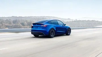 Imagen dinámica del Tesla Model Y 2024 donde se aprecia su diseño trasero y perfil lateral.