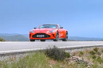 Vista dinámica del Aston Martin Vantage 2024 en carretera abierta.