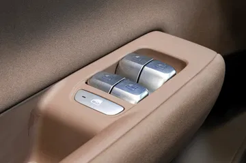 Detalle de los mandos de ajuste de asiento en cuero marrón