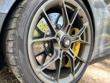 Primer plano de la llanta del Porsche 911 GT3 Touring, destacando su diseño y frenos