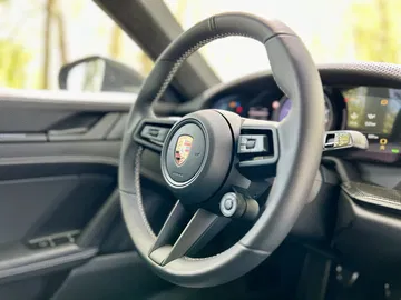 Imagen del volante deportivo y el interior sofisticado del Porsche 911 GT3 Touring.