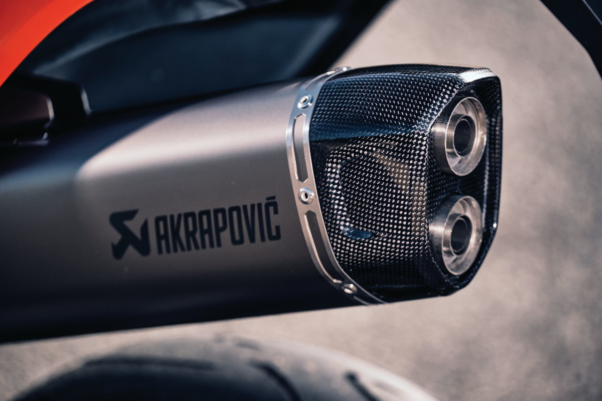 Escape deportivo Akrapovic con detalle de logo.