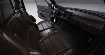 Vista interior del Alpha Wolf con asientos de cuero marrón y detalles premium.