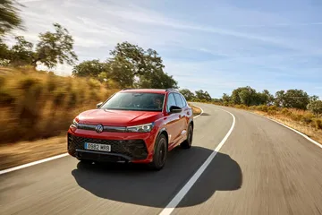 Volkswagen Tiguan 2024 en movimiento, mostrando su diseño frontal y lateral.