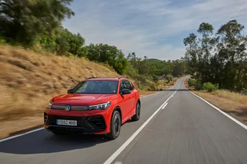 Volkswagen Tiguan 2024 capturado en movimiento, mostrando su diseño lateral.