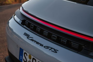 Vista cercana del distintivo trasero del Porsche 911 GTS T-Hybrid.