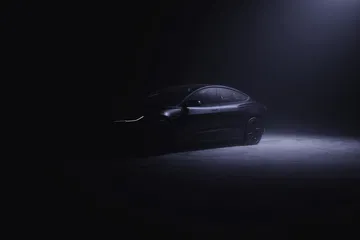 Tesla Model 3 en ambiente oscuro resaltando su silueta lateral