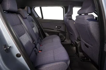 Vista lateral interna enfocando asientos traseros con tapicería moderna y detalles elegantes.