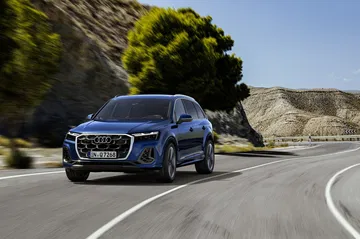 El Audi Q7 muestra su perfil lateral en movimiento, elegancia y dinamismo.