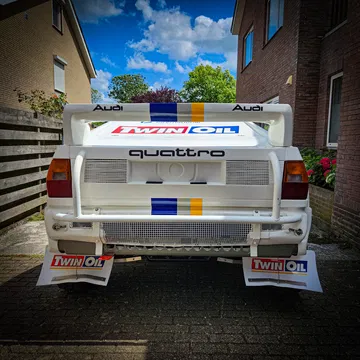 Vista trasera de un Audi Quattro, mostrando su alerón icónico y diseño robusto.