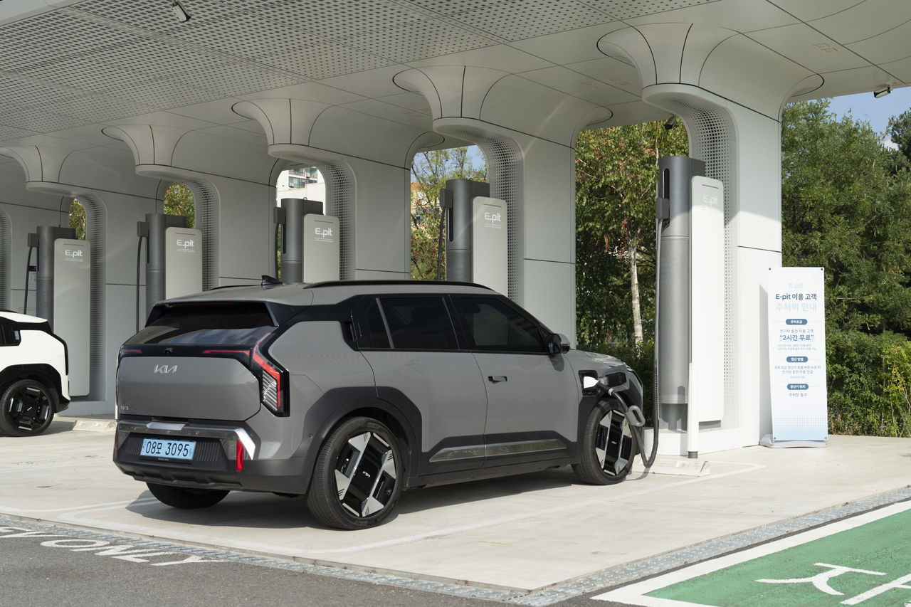 El KIA EV6 recargando en una estación de carga, mostrando su diseño trasero y lateral.