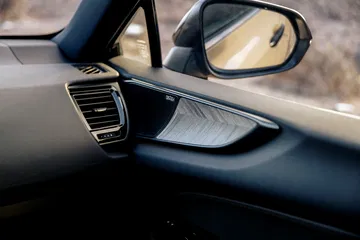 Vista del espejo lateral y acabados interiores del Lexus NX.