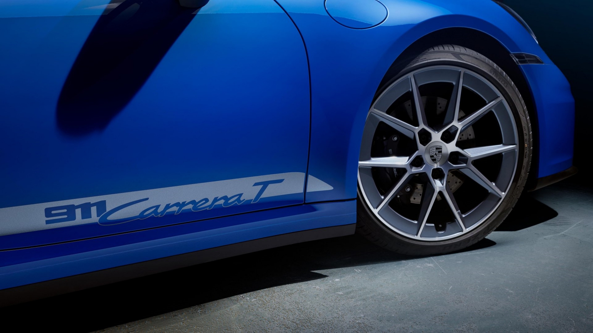 Vista lateral enfoca llantas y diseño deportivo del Porsche 911 Carrera T.