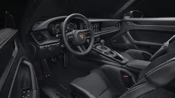 Cabina del Porsche 911 GT3 992 con enfoque en volante y consola central.
