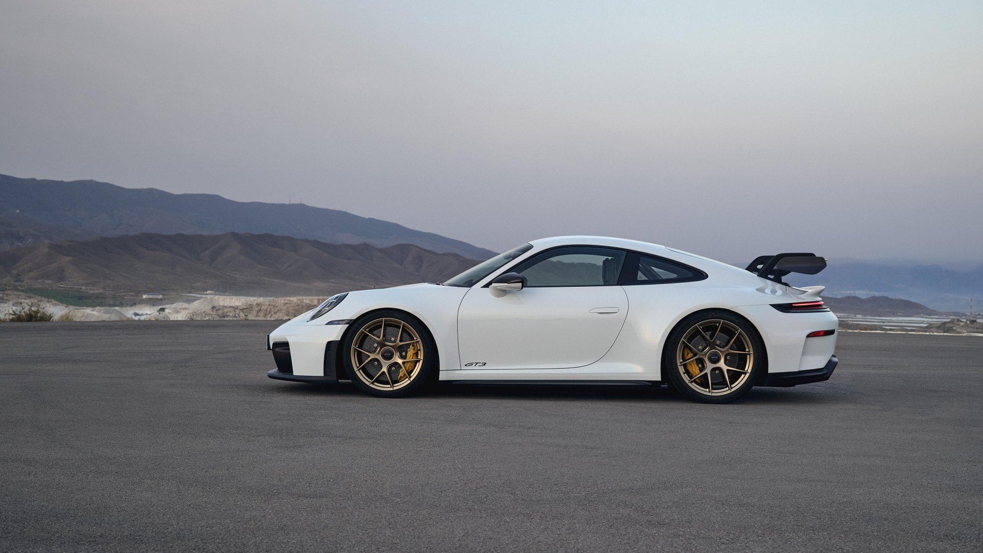 Perfil dinámico Porsche 911 GT3, aerodinámica depurada y diseño icónico.
