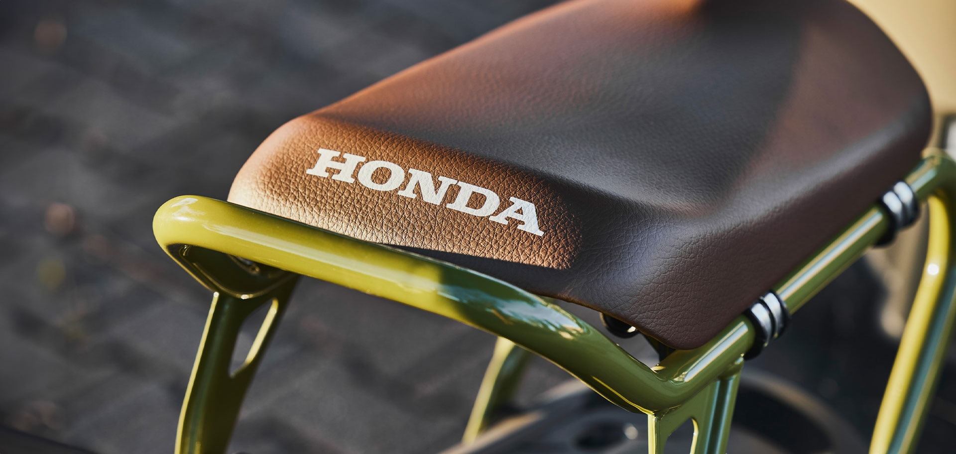 Asiento mostrando el emblema de Honda con estructura de soporte visible.