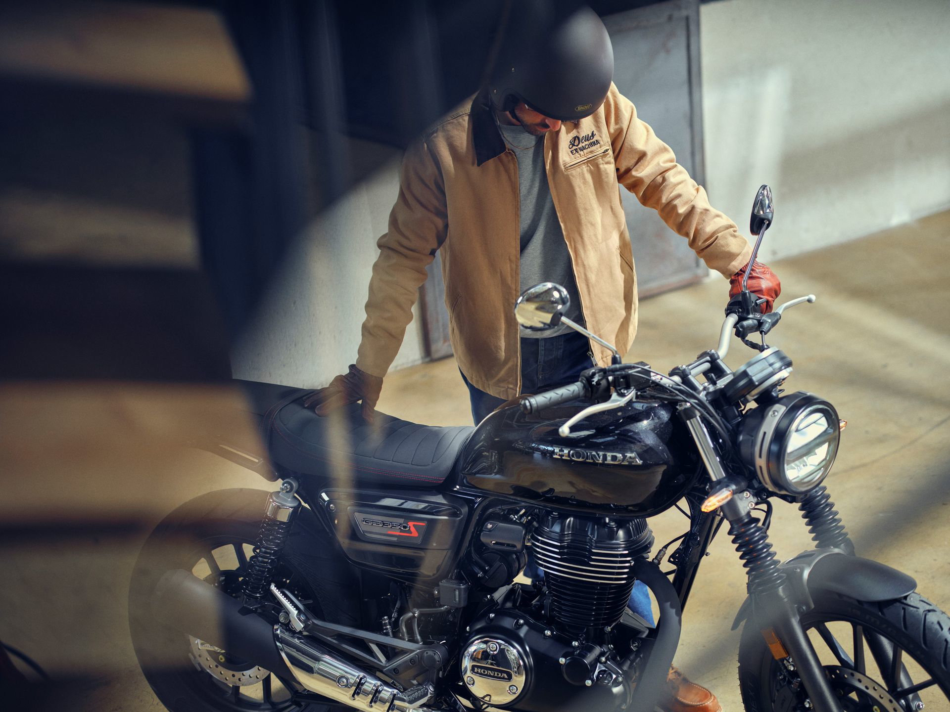 Muestra la Honda GB350S desde un ángulo lateral, destacando su estilo neoclásico.