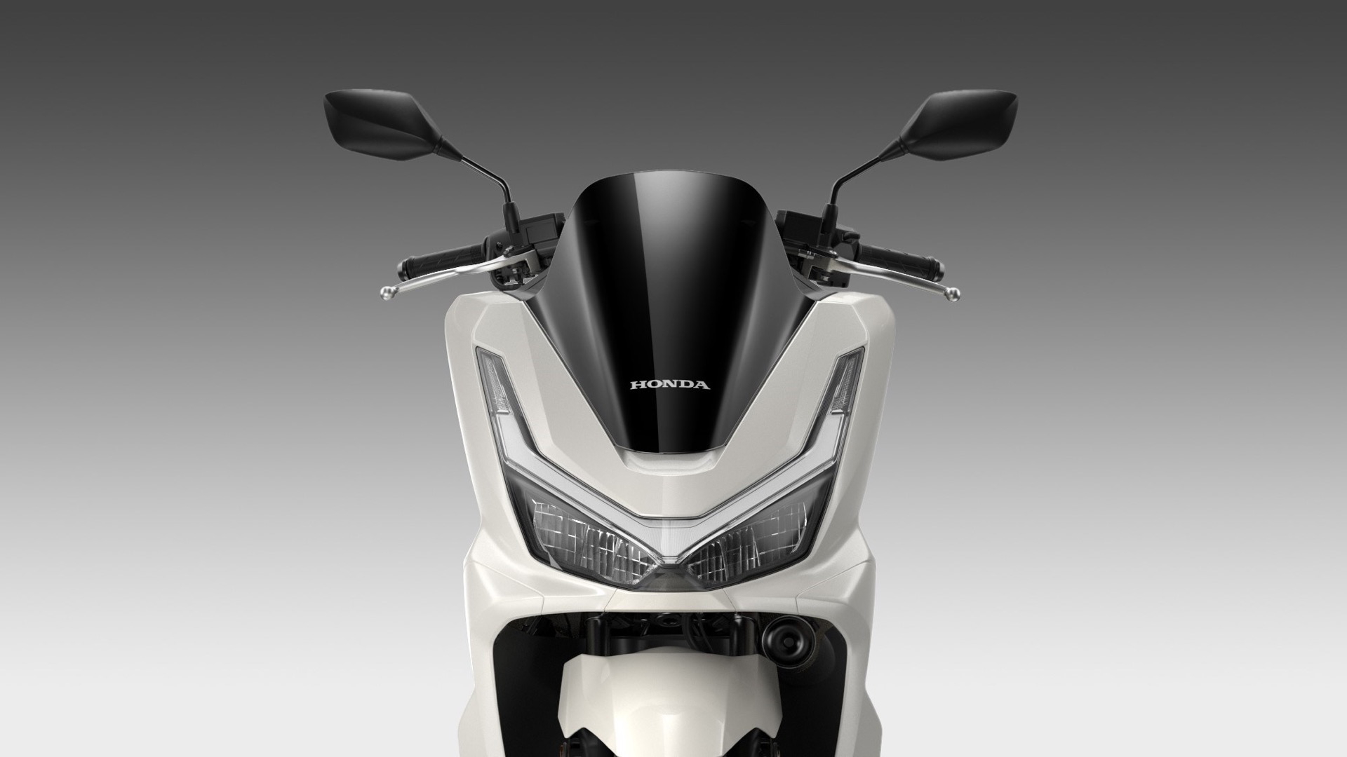 Vista frontal del renovado Honda PCX 125, muestra diseño aerodinámico y faros LED.