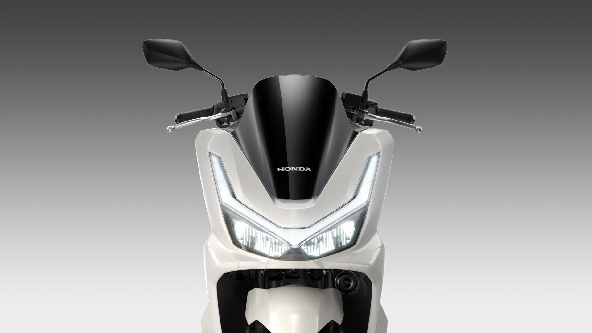 Vista frontal del renovado Honda PCX 125 resaltando su diseño práctico y moderno.