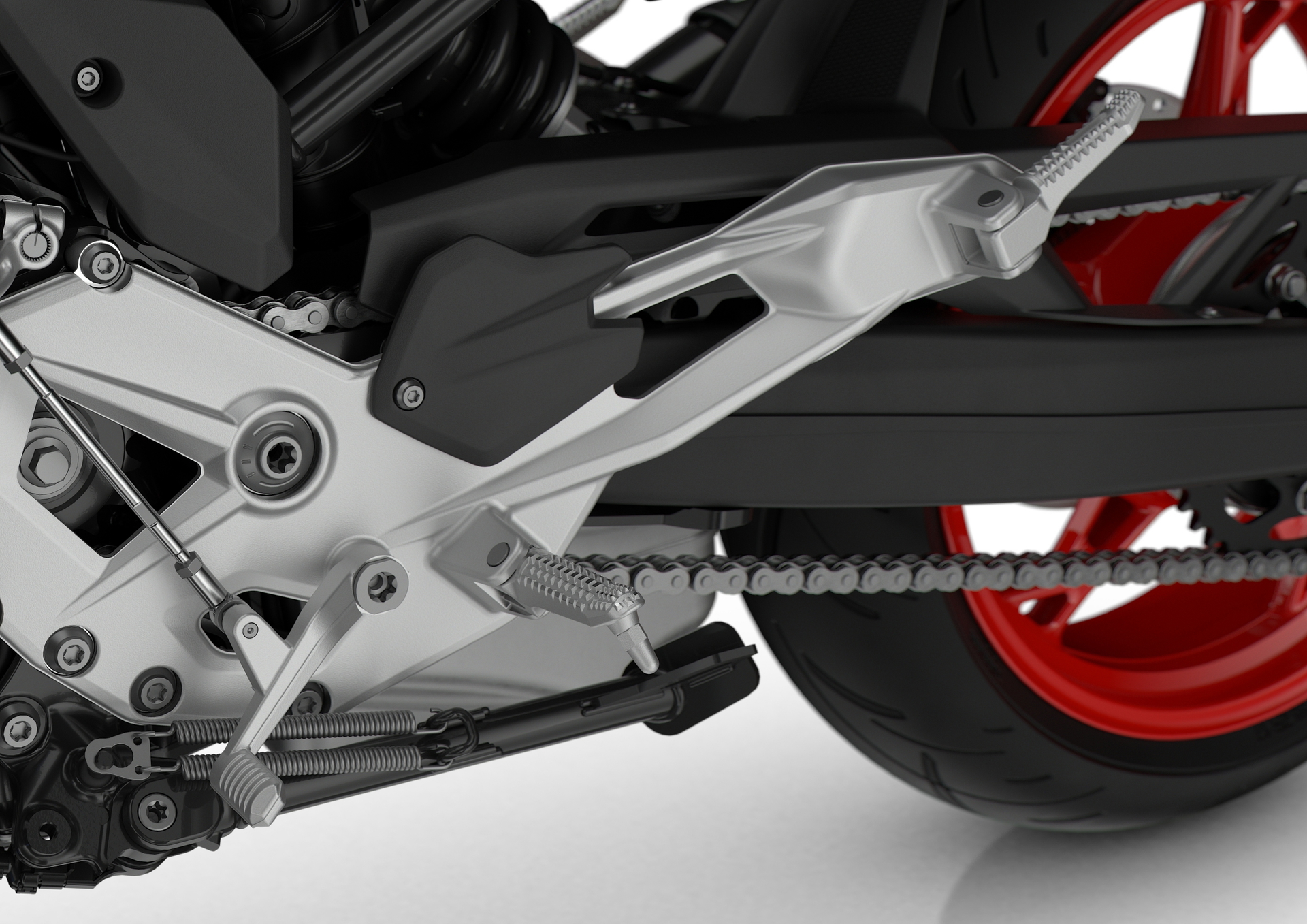 Detalle del sistema de transmisión del BMW F 900 R, destacando su precisión y diseño.