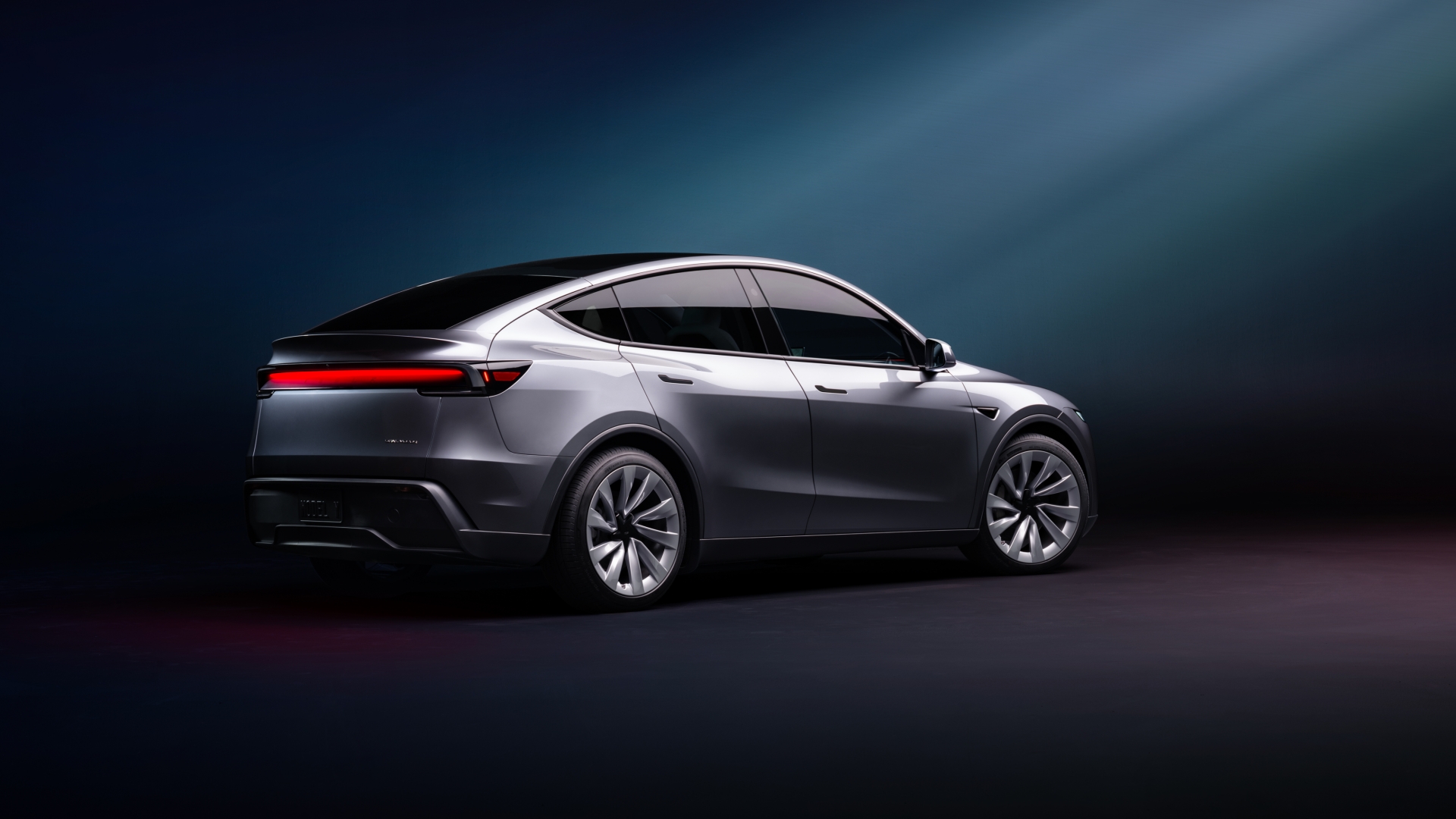 Vista del Tesla Model Y 2025, mostrando su diseño contemporáneo y aerodinámico. Vista del Tesla Model Y 2025, mostrando su diseño contemporáneo y aerodinámico.