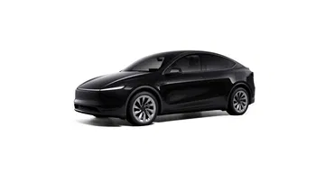Vista lateral del Tesla Model Y 2025, mostrando su diseño elegante y moderno.