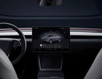 Interior moderno y minimalista con pantalla central táctil de gran tamaño.