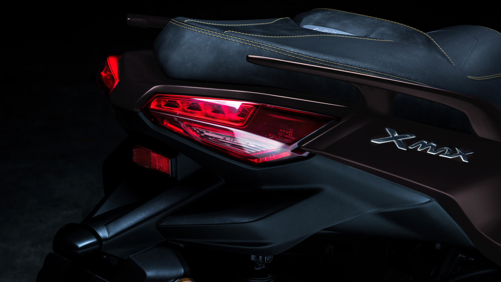 Vista detallada del diseño trasero del Yamaha XMAX 2025, destacando las luces y líneas elegantes.