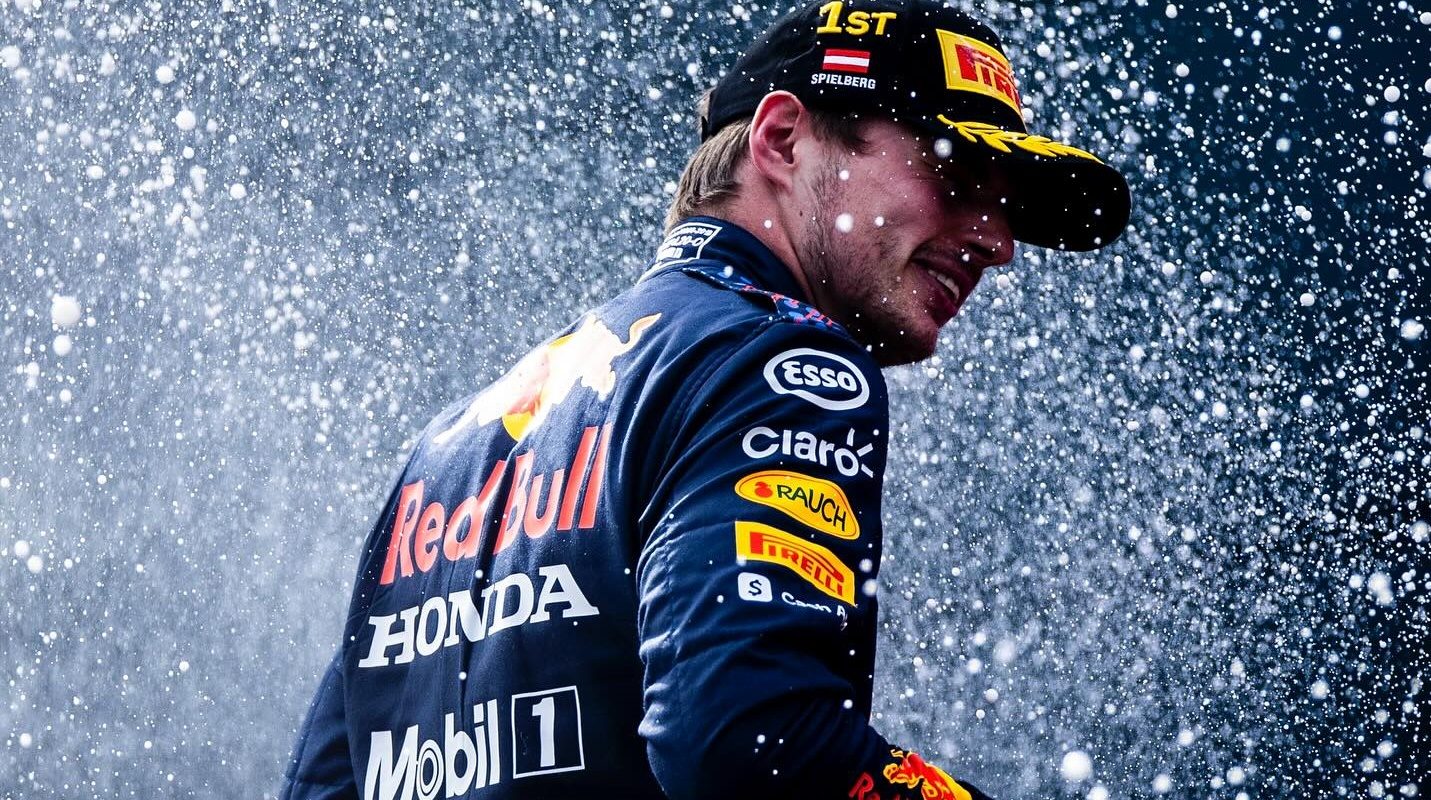 Max Verstappen celebra en su Red Bull tras una victoria, mostrando su felicidad y determinación.