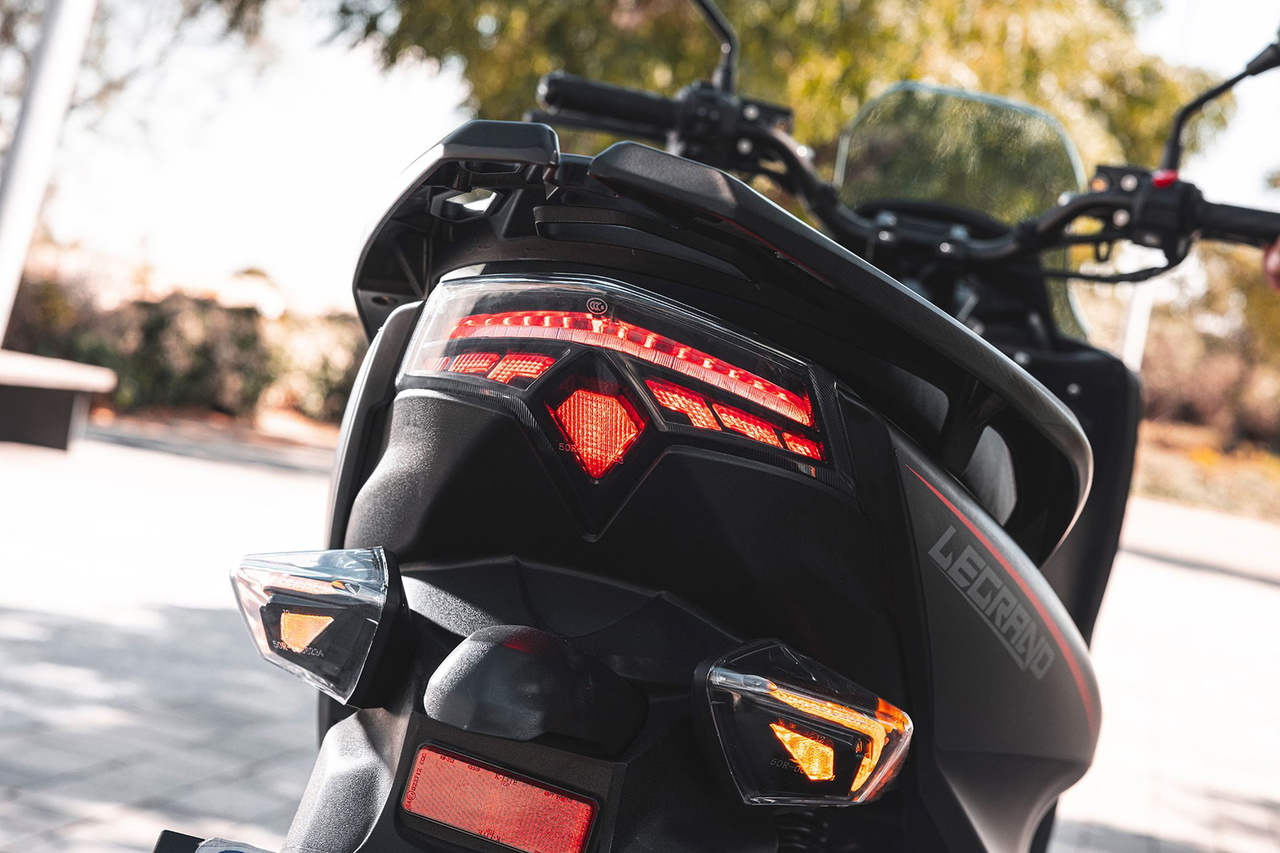 Vista detallada de la parte trasera de la moto, con diseño moderno y luces LED.