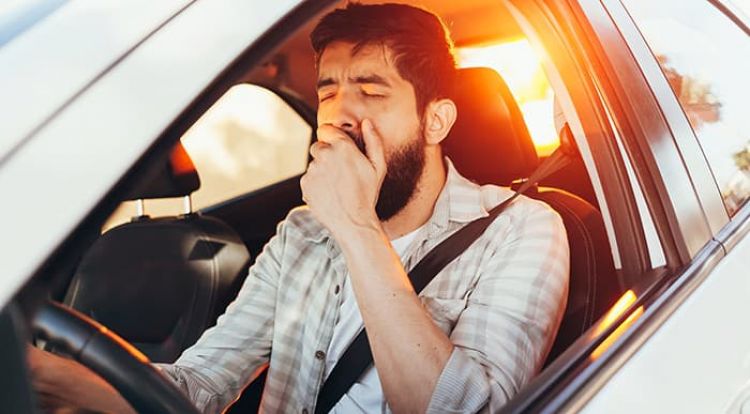 Tired Man Yawning While Driving His Car