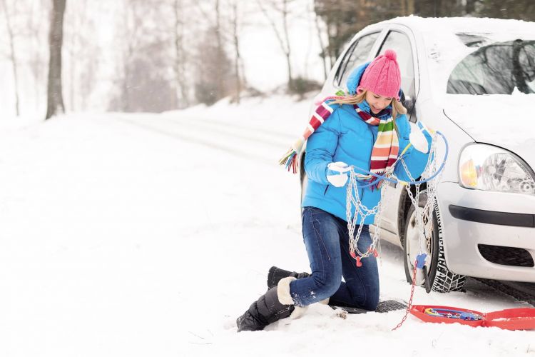 Woman With Winter Car Tire Chains Snow